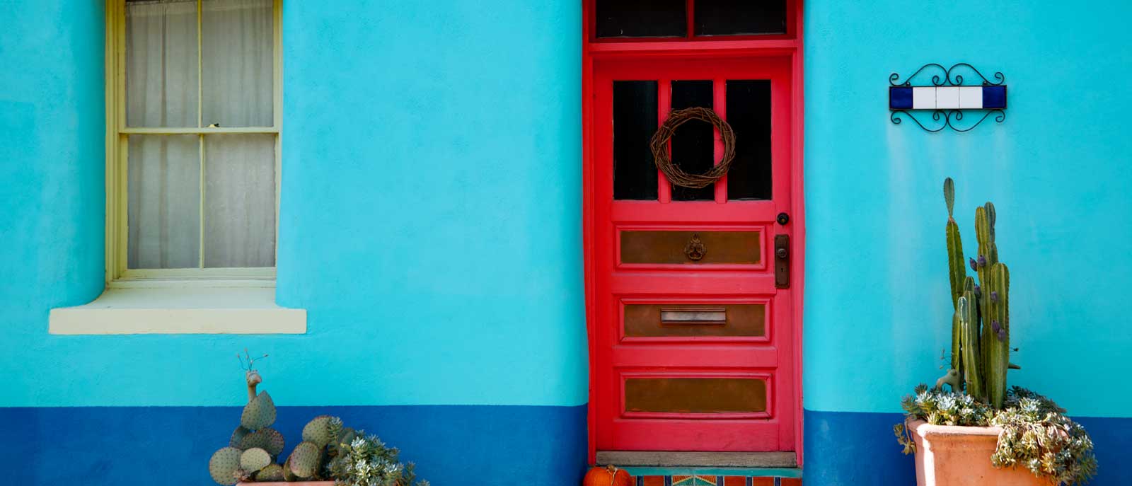 Warm blue wall color with red door